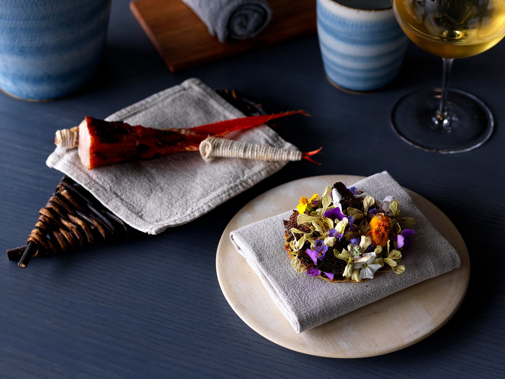  The charcoal-grilled red snapper with habanero miso. A string is winded on to the red snapper to be able to eat with your hands.  The flower tart uses a puree made of black truffles.  Photography Jason Loucas
