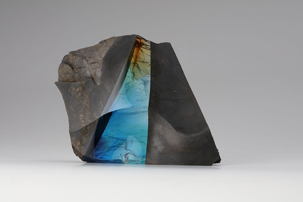 Art object “Symbiosis #17” by Suguru Iwasaka. Combining a rock, a piece of nature, with a glass, a man-made creation, allowing the two to co-exist together in a new form. Photography by Suguru Iwasaka